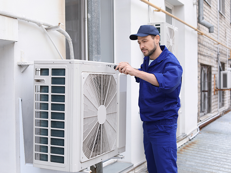 men checking aircondition exhaust