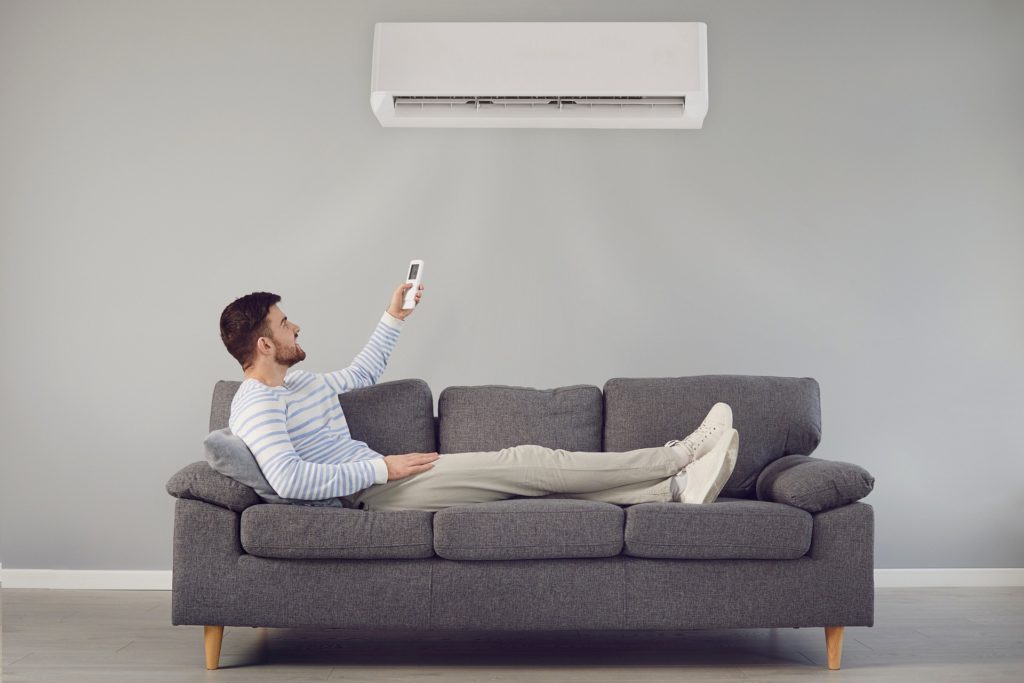 man on sofa with air-conditioner